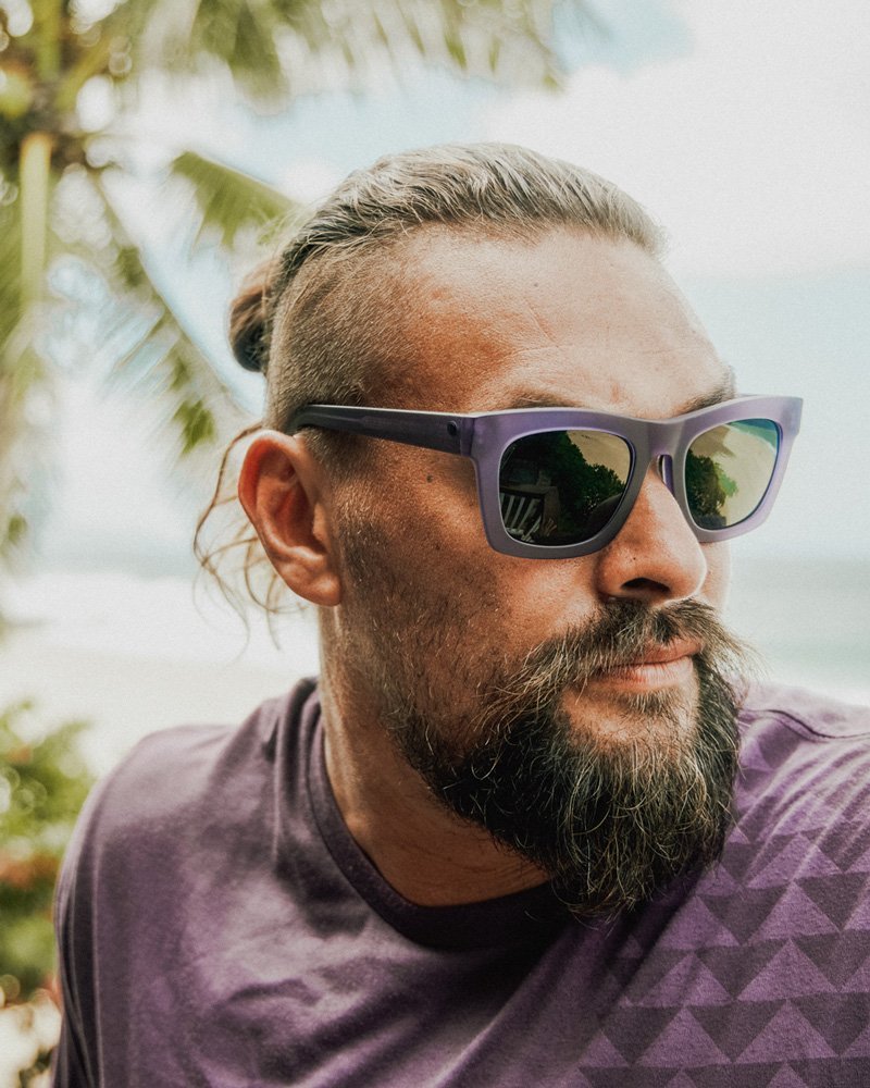 Jason Momoa wearing the Unity Purple Nakoa Tee and Unity Purple Crasher sunglasses